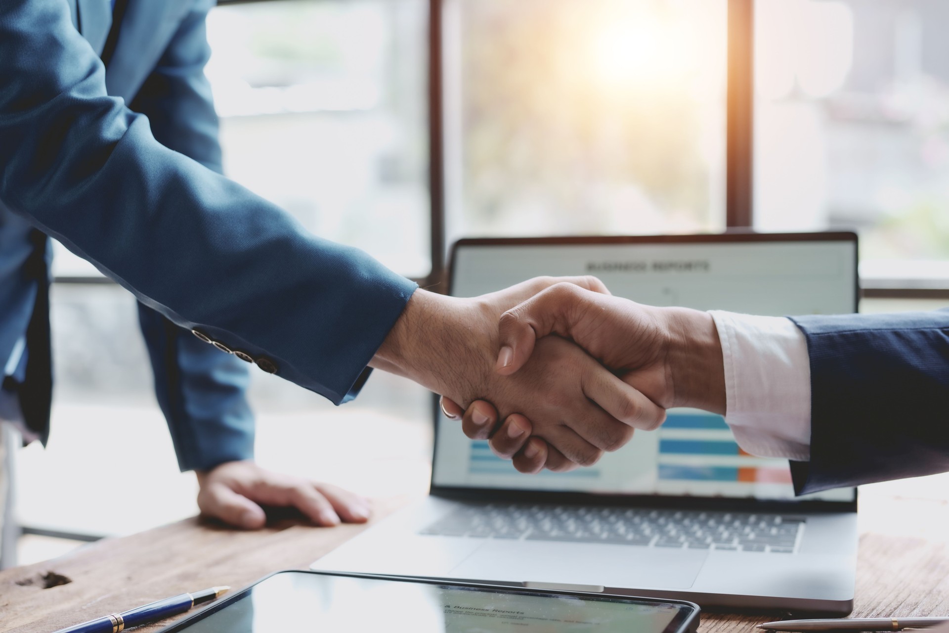 Business success. Business people handshake agreement confirmed in the investment business. Successful business people meeting together.
